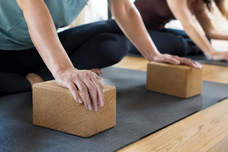 Utilisation de briques de yoga pour sécuriser les appuis et éviter les faux mouvements
